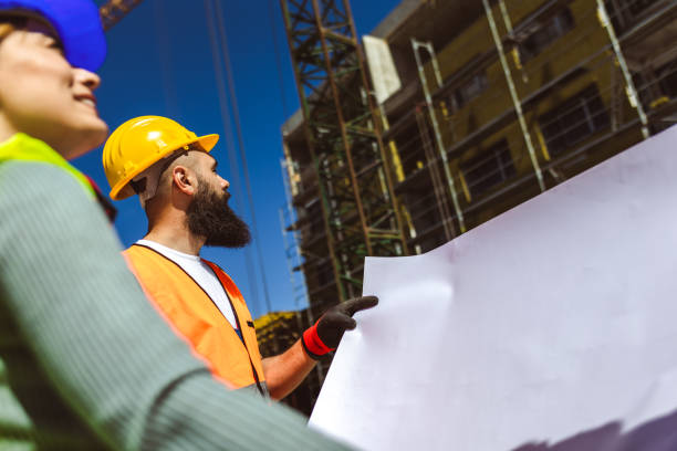 istock Construction team planning a building blueprint project on site with collaboration for architect innovation. Architecture, design and engineers with teamwork for successful 2158853558