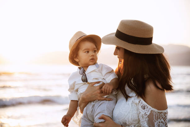 istock Mother and Son Smiling at Sunset Beach 2158853696