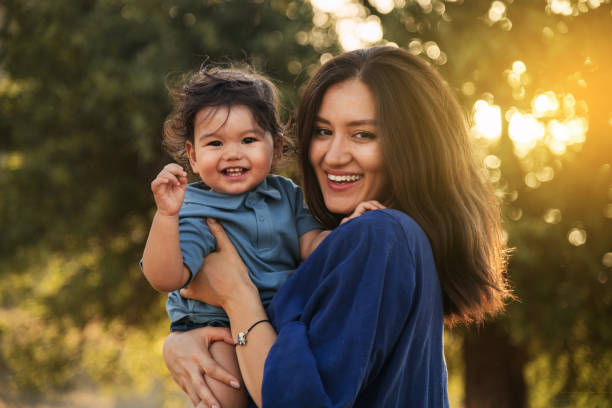 istock Mother Holding Her One Year Old Son in Nature 2158853809