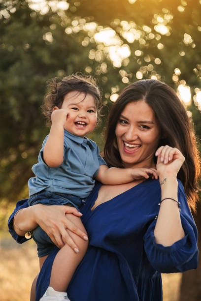 istock Mother Holding Her One Year Old Son in Nature 2158853823