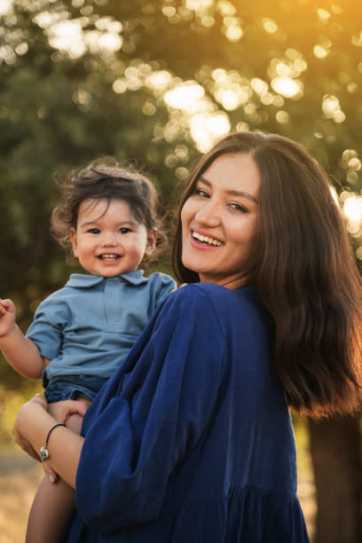 istock Mother Holding Her One Year Old Son in Nature 2158853824