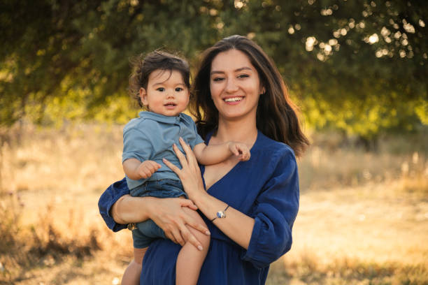 istock Mother Holding Her One Year Old Son in Nature 2158853826