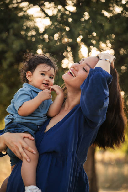 istock Mother Holding Her One Year Old Son in Nature 2158853835