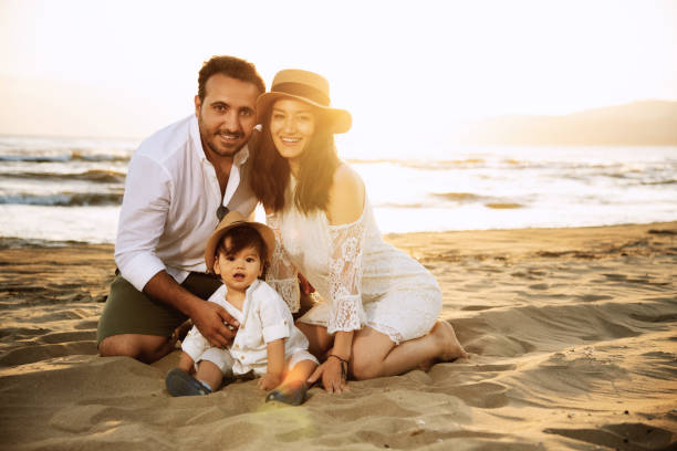 istock Happy Family on the Beach at Sunset 2158853838