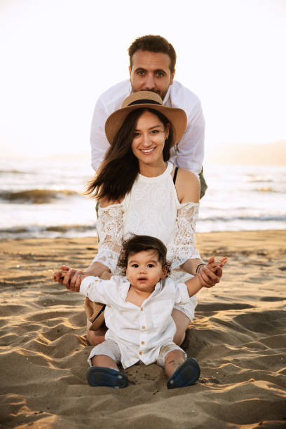 istock Happy Family on the Beach at Sunset 2158853852