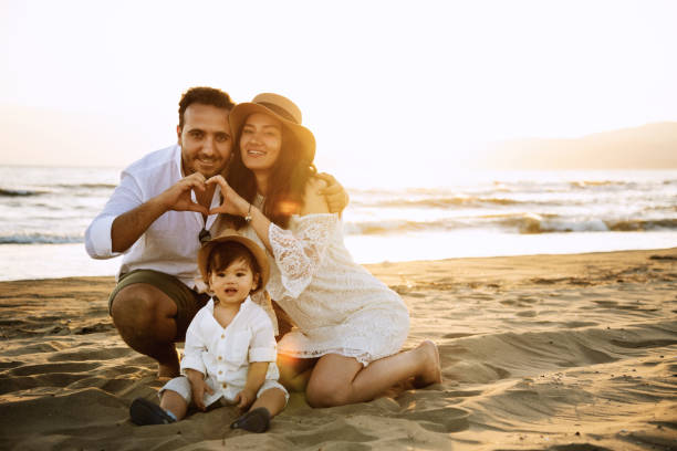 istock Happy Family on the Beach at Sunset 2158853854