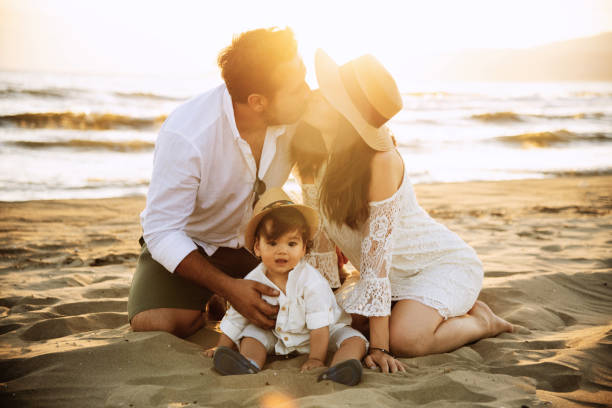istock Happy Family on the Beach at Sunset 2158853867
