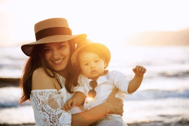 istock Mother and Son Smiling at Sunset Beach 2158853880