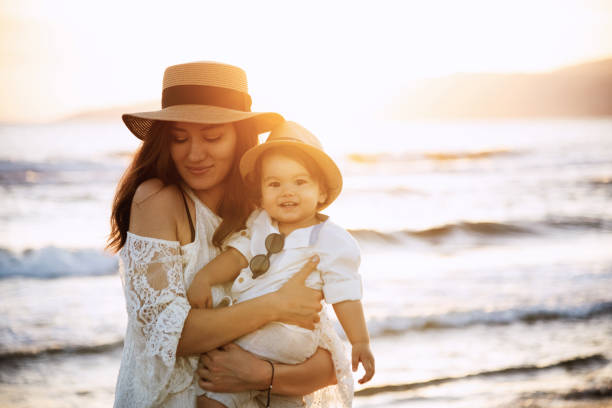 istock Mother and Son Smiling at Sunset Beach 2158853881