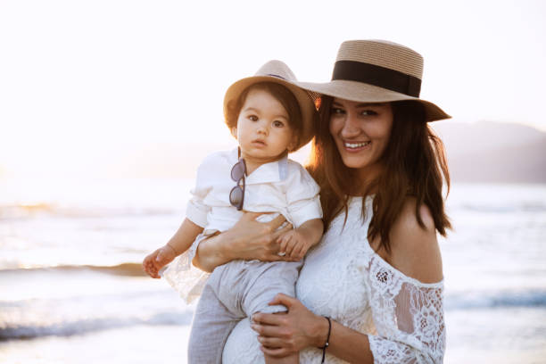 istock Mother and Son Smiling at Sunset Beach 2158853887