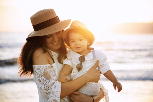 istock Mother and Son Smiling at Sunset Beach 2158853925