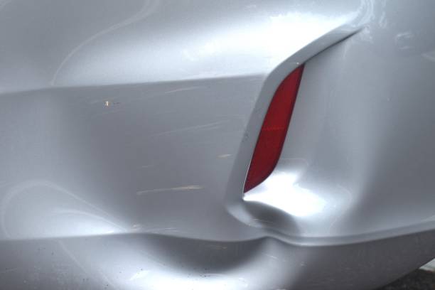 istock pound and scratch from accident on bumper of silver color car background and texture 2158854106