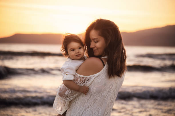 Mother and Child Enjoying Sunset on the Beach