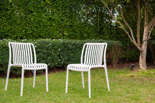 istock Two plastic white chairs in the garden 2158854645