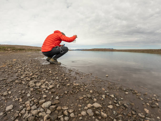 istock Man filtering Water from Lake in Iceland 2158854863