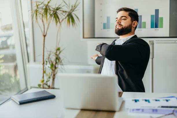 istock Businessman stretching at his desk during a work day 2158855633
