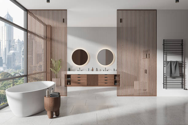 istock Stylish home bathroom interior with tub, double sink and panoramic window 2158855783