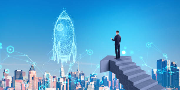 istock A man in a suit standing on stairs, looking at a holographic roc 2158856029