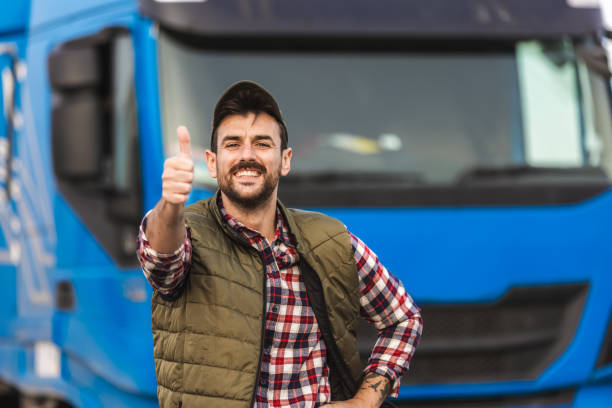 istock Happy confident male driver standing in front on his truck 2158856624