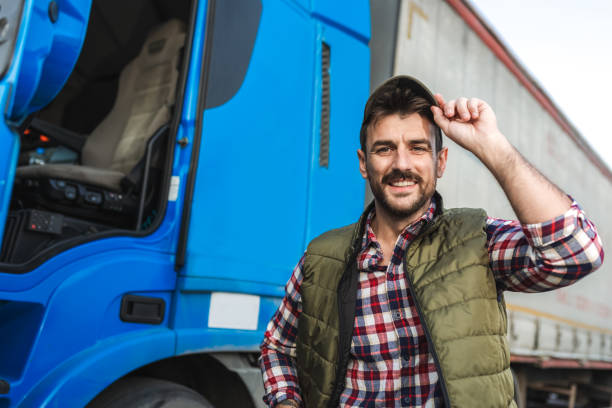 istock Happy confident male driver standing in front on his truck 2158856642