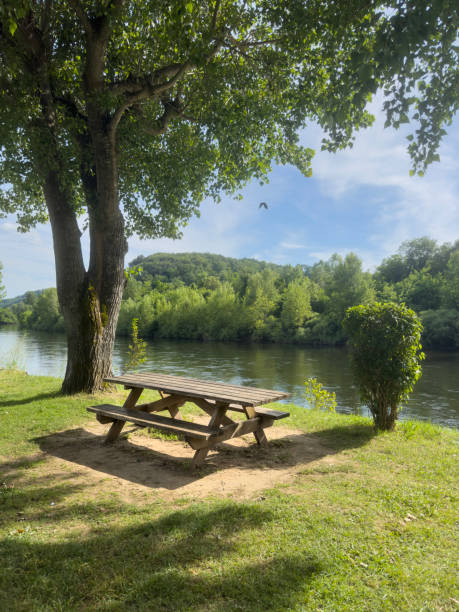 empty wooden picnic table in the park by river