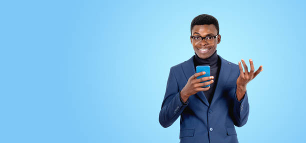 istock Black businessman with smartphone in hand, copy space background 2158856991