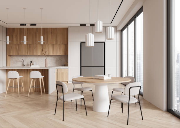 istock Modern dining room and kitchen featuring light wood furniture and large windows, minimalistic style, bright and airy space, concept of contemporary interior design.  3D Rendering 2158857028