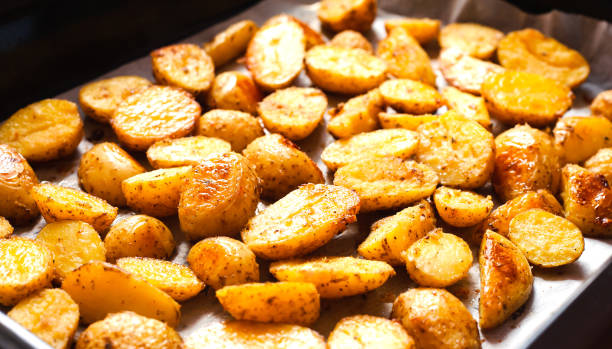 istock Baked crispy potato on baking tray. Side view. 2158857211
