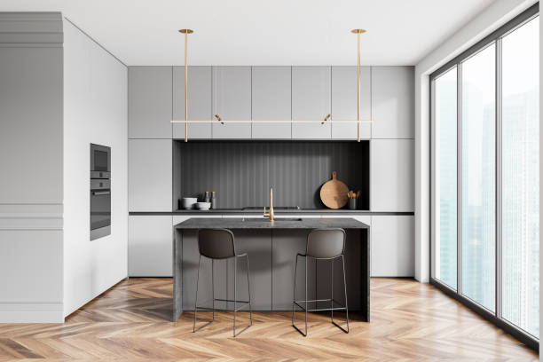 istock Classical home kitchen interior with bar island, cooking cabinet and window 2158857314