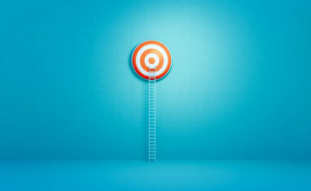 istock Ladder Leaning Onto A Bull's Eye Target On Blue Background 2158857320