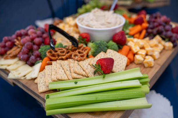 istock Graze Board. The board includes a variety of cheeses, fruits, vegetables, dips and crackers. 2158862224