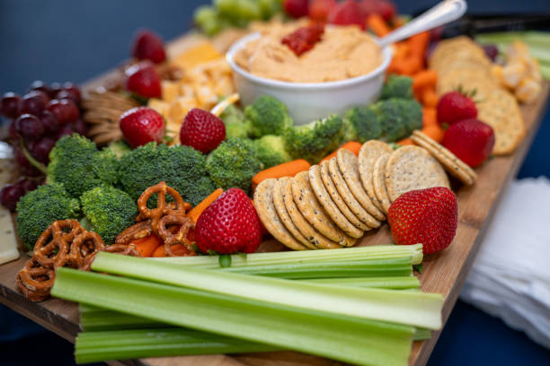 istock Graze Board. The board includes a variety of cheeses, fruits, vegetables, dips and crackers. 2158862225