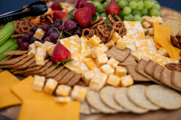 istock Graze Board. The board includes a variety of cheeses, fruits, vegetables, dips and crackers. 2158862267