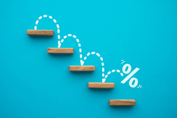Percent sign moving down from top stair on blue background.