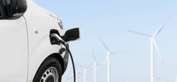 istock Charging electric van and wind turbines in a background 2158865684