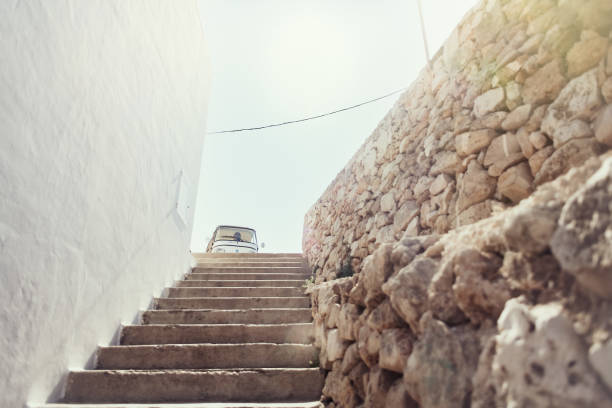 The white steps going down the cliff to Port'Alga from the Tuk Tuk tour in Polignano a Mare, Italy