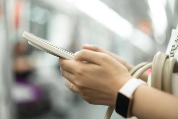 istock asian female using smart phone in subway 2158865841