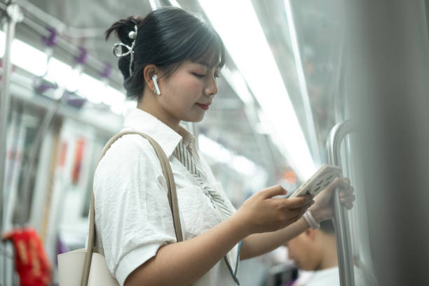 istock listen music with smart phone at subway 2158866114