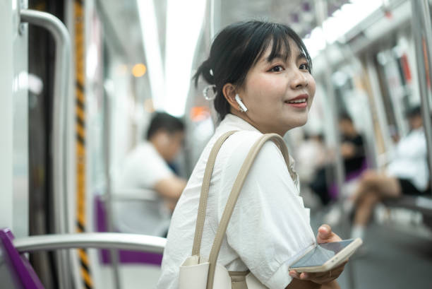 istock listen music with smart phone at subway 2158866120