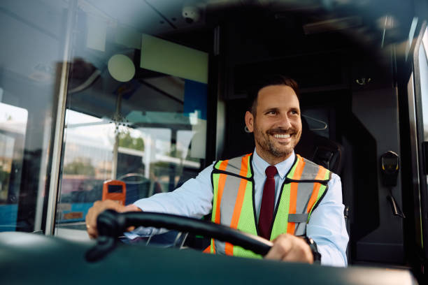 Happy bus driver driving a bus.