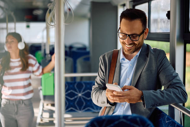istock Happy entrepreneur texting on cell phone while riding in a bus. 2158867387