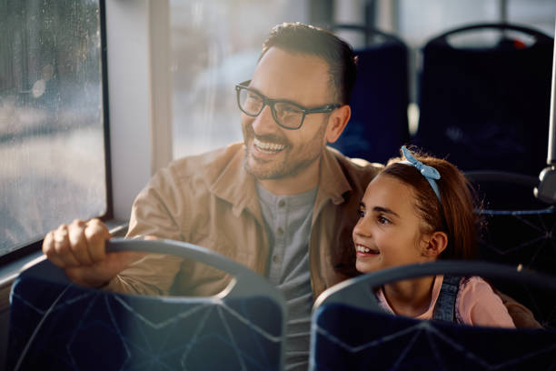 istock Happy father and daughter looking through the window while commuting by bus. 2158867594
