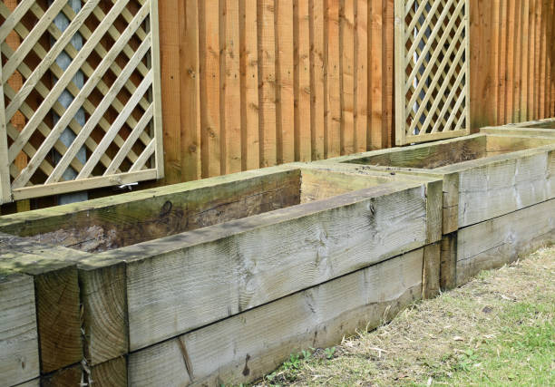 istock Empty railways sleeper raised garden beds. Lawn, fence and decorative trellis 2158867770