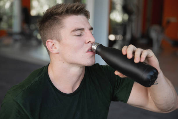 istock Tired Caucasian Athlete Drinking water from Insulated bottle 2158867972