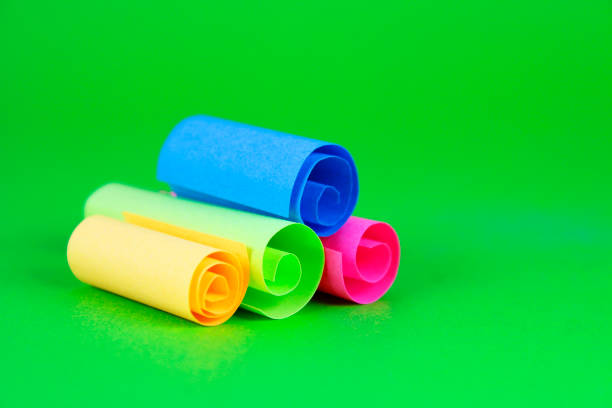 Extreme macro of multicolor background from different colors papers. Abstract colorful vibrant paper textures. Selective focus, shallow depth of field.