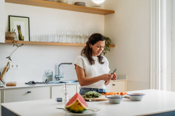 istock Woman cooking at home 2158869357