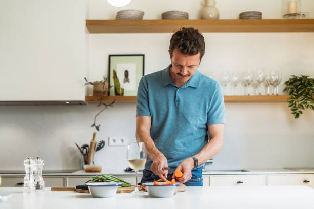 istock Man cooking at home 2158869438
