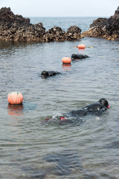 istock traditional female divers 2158871294