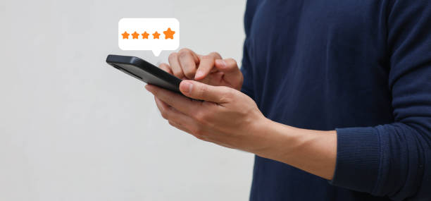 istock close up on customer man hand check on gold five star rating feedback icon and press level best rank  for give score point to review the service business concept 2158874785
