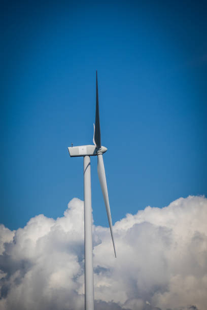 istock wind turbine, under a blue sky with a few clouds 2158874839